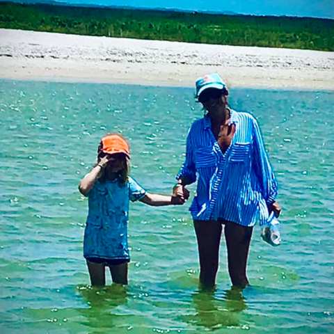 a group of people standing next to a body of water