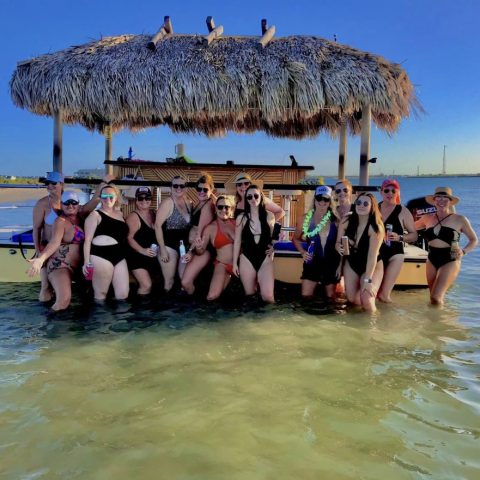 a group of people standing next to a body of water