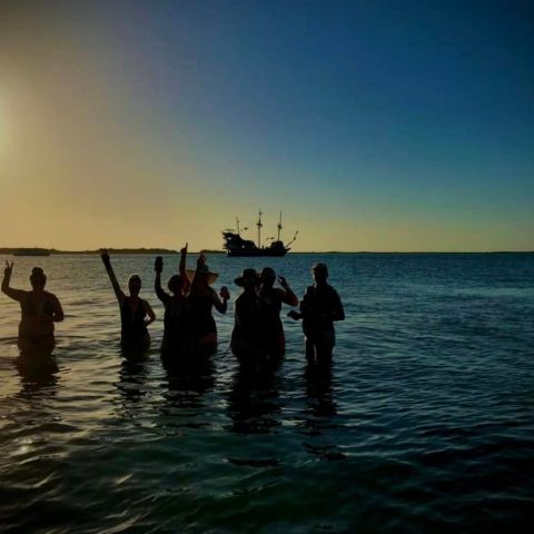 a group of people standing next to a body of water