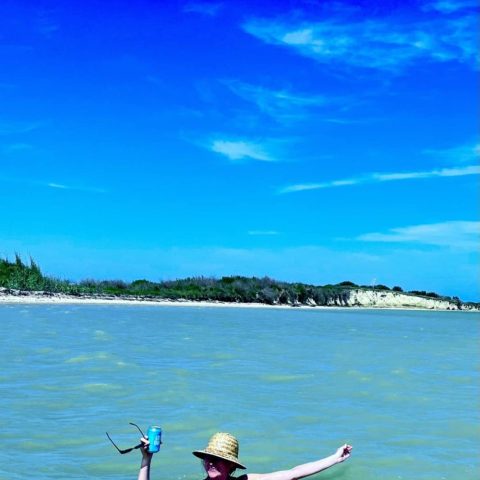 a person standing next to a body of water