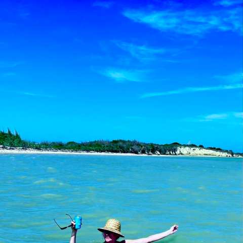 a person standing next to a body of water