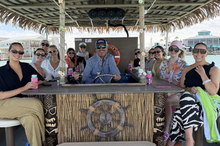 Group posed on a tiki pedal boat with a nautical theme.